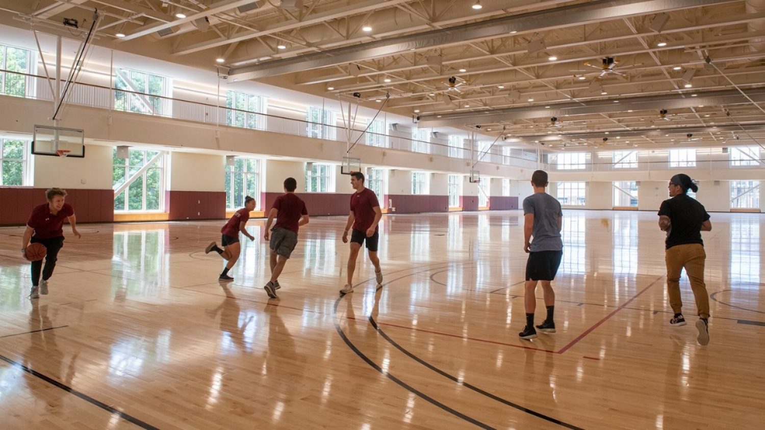 A group of students plays basketball on the new Recreation Center courts
