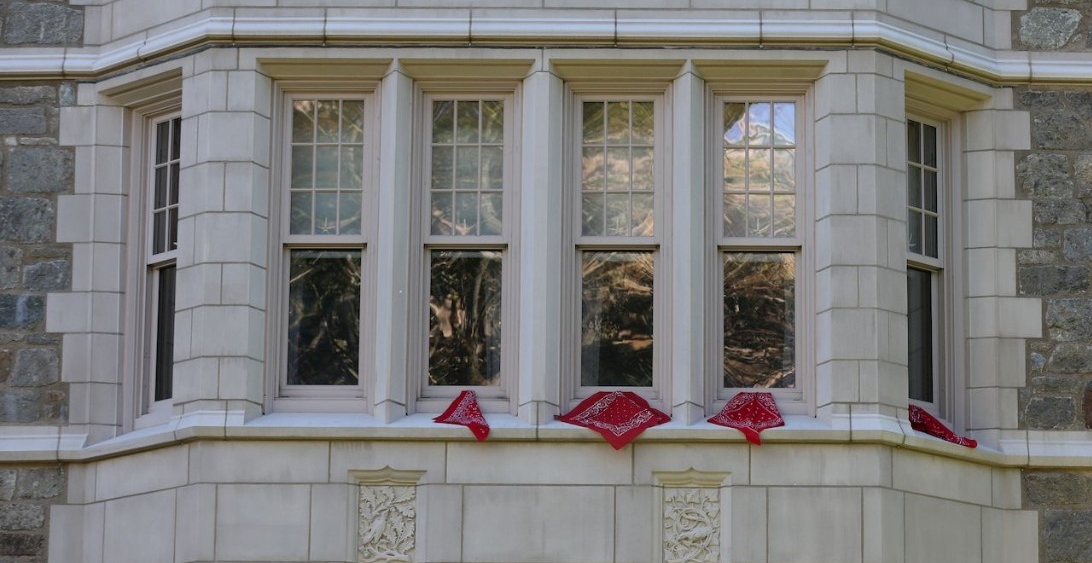 Red bandannas beneath windows at BC