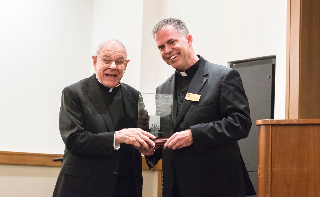 John W. Padberg, S.J., at left, is presented with the George Ganss, S.J. Award by Casey Beaumier, S.J., director of the Institute for Advanced Jesuit Studies at Boston College. (Gary Wayne Gilbert)