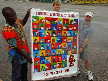 BC TechTrek Ghana leaders John Gallaugher and Elizabeth Bagnini with a welcome banner presented as a gift from bus driver Alex Asare, who has been with the program for three years.