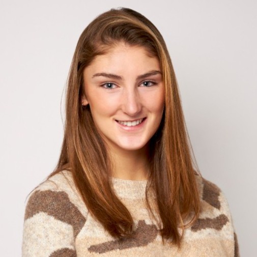 caucasian girl with long light-brown hair in a striped sweater