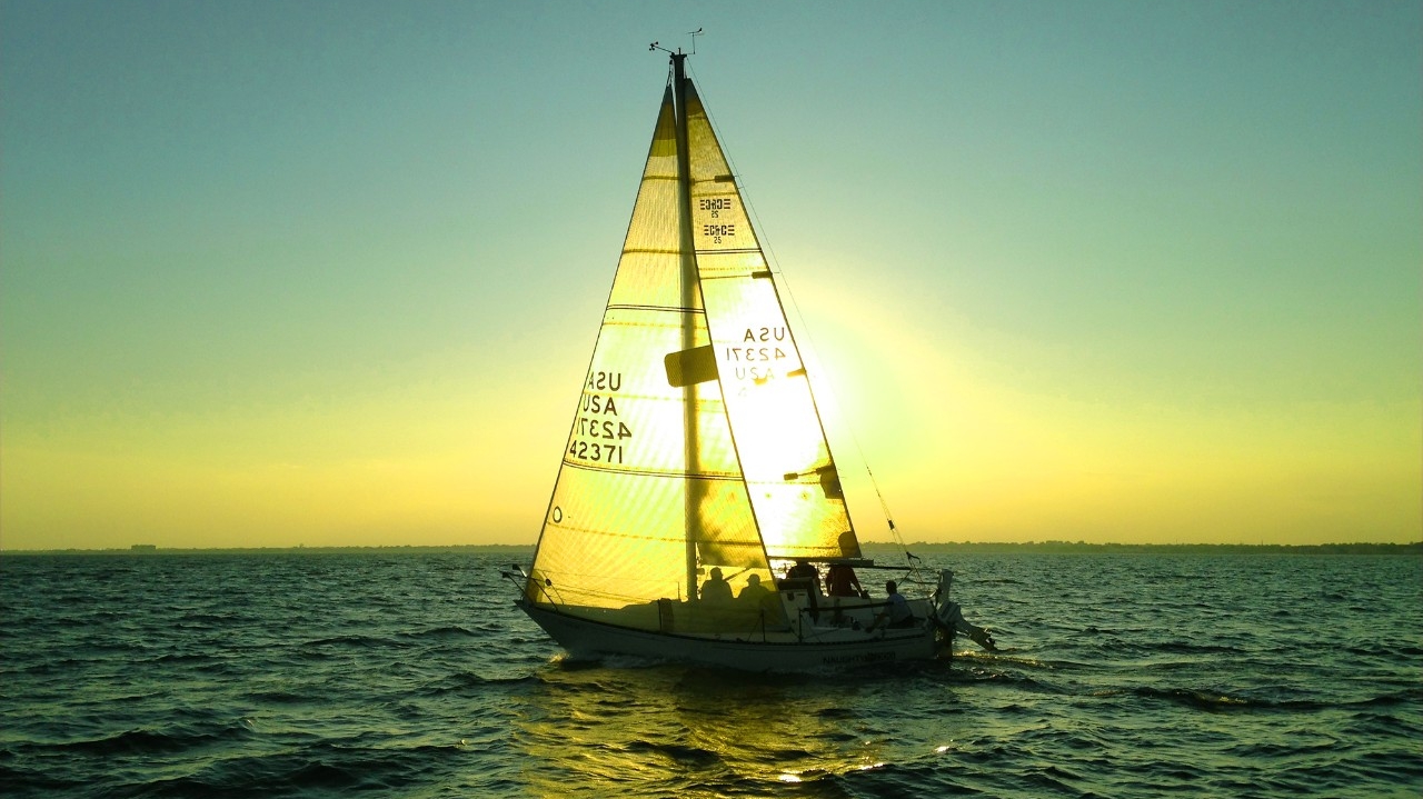 Sailboat with the sun on the horizon