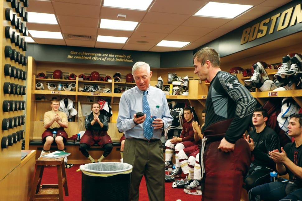 York with game puck and players in the men's hockey lockeroom