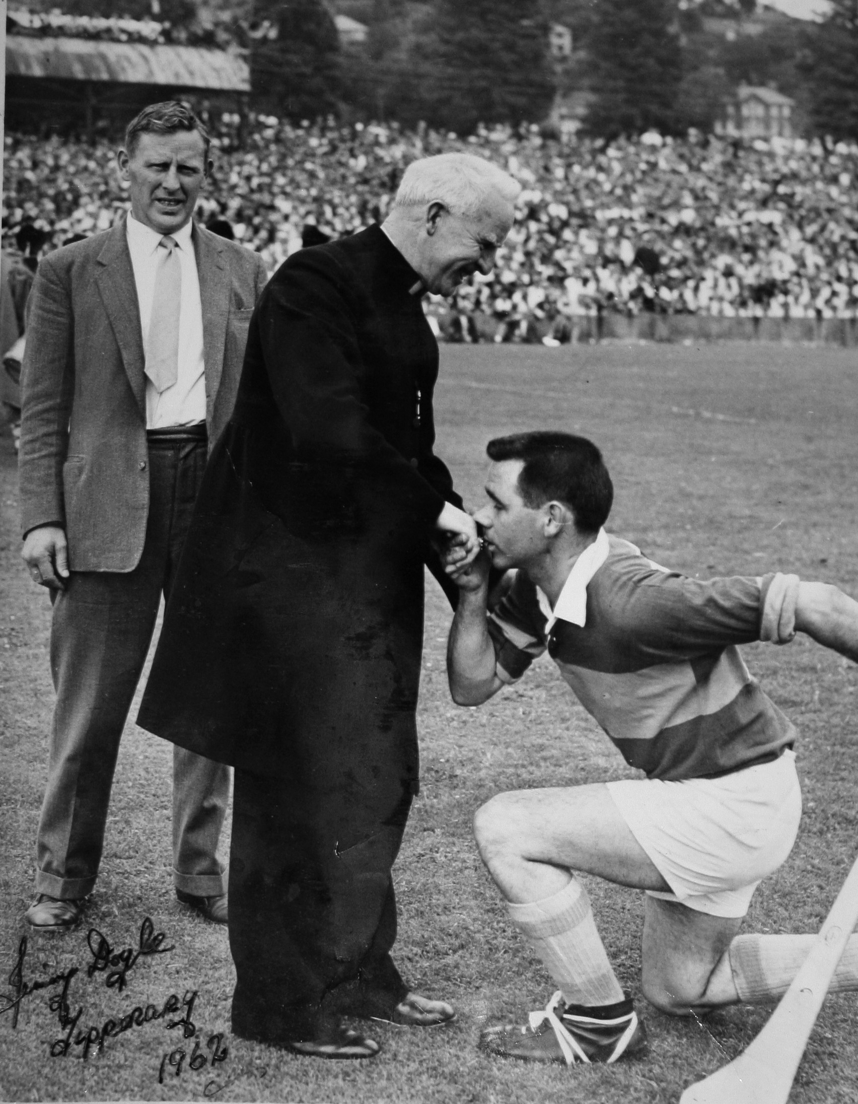 The traditional image of the team captain kissing the bishop's ring before the start of the match. This image shows Bishop Lucy and Jimmy Doyle at the 1962 Munster Senior Hurling Final.