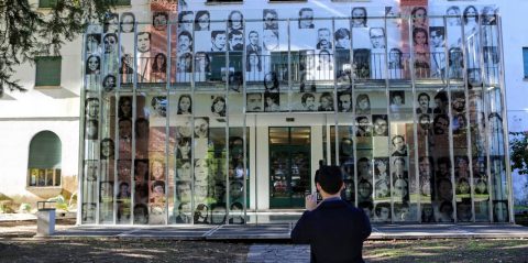 Assistant Professor of the Practice of Philosophy David Storey takes a photo of the entrance to a memorial museum located in buildings that once housed a detention and torture center on the site of Argentina's former naval academy.