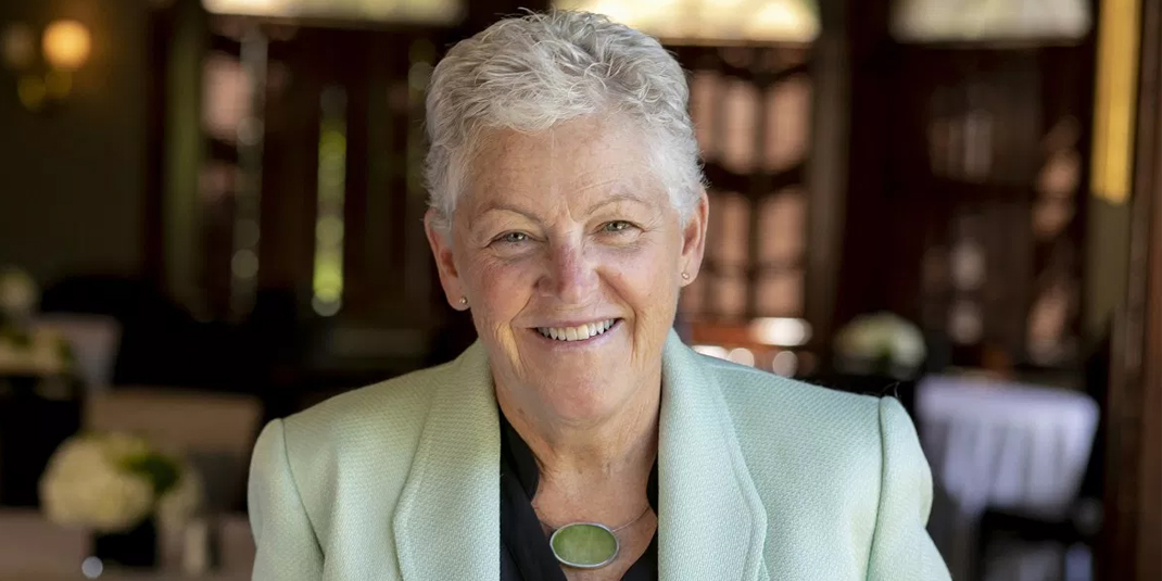 Gina McCarthy, smiling in a suit jacket