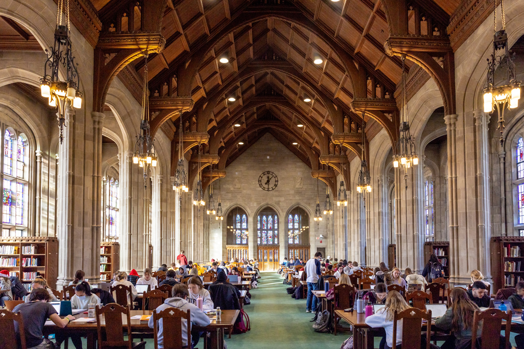 students studying in a collegiate gothic library