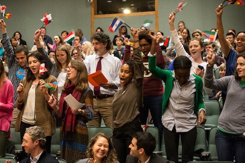 People celebrate waving flags at a national swearing-in ceremony