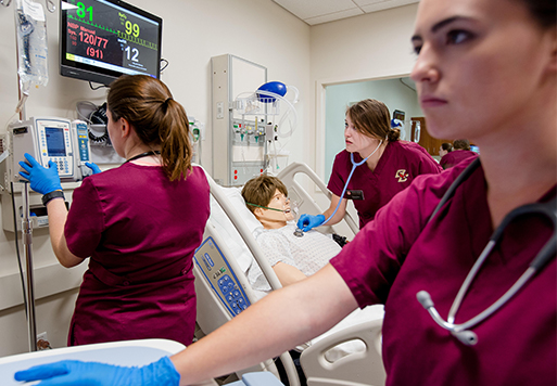 nurses working with a practice mannequin