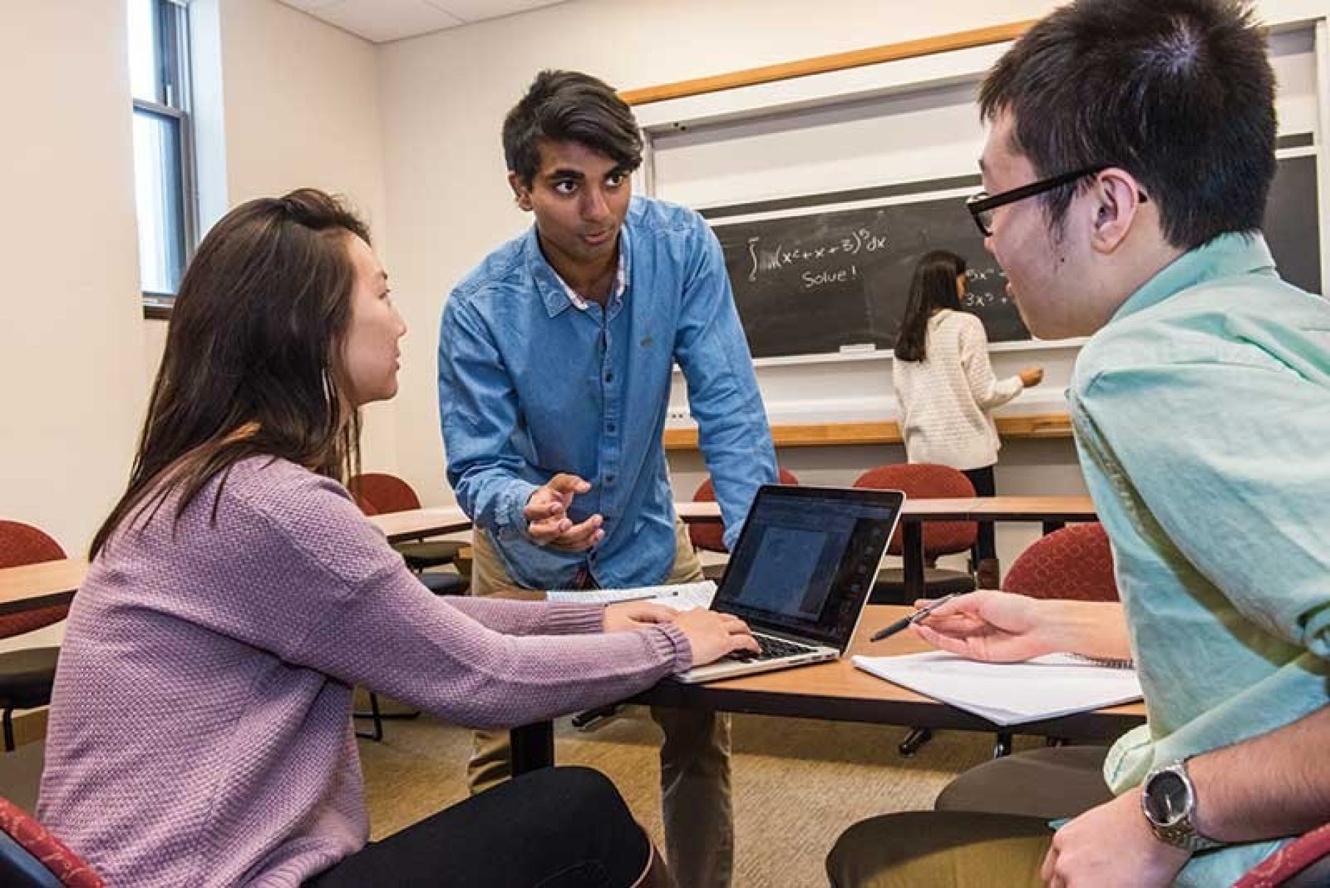 Three students in a classroom