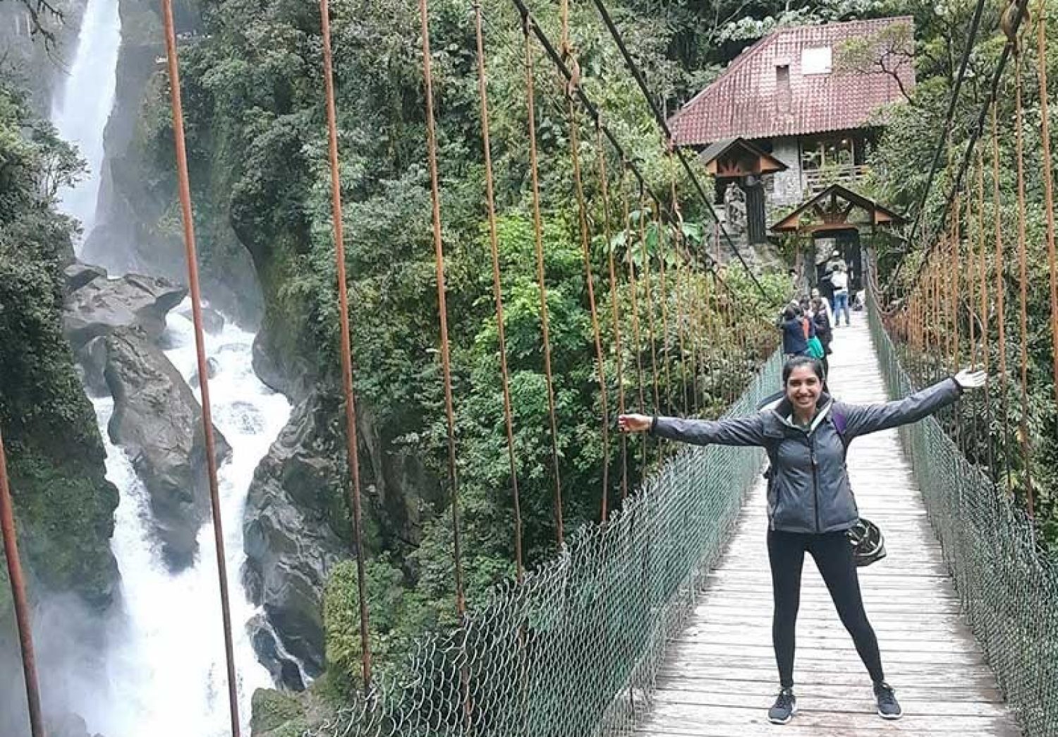 A student standing on a bridge in a foreign country