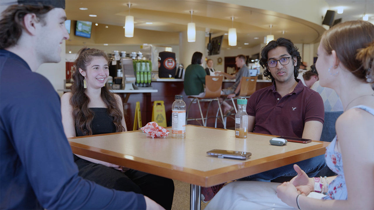 four students sitting at a table in Hillside Cafe
