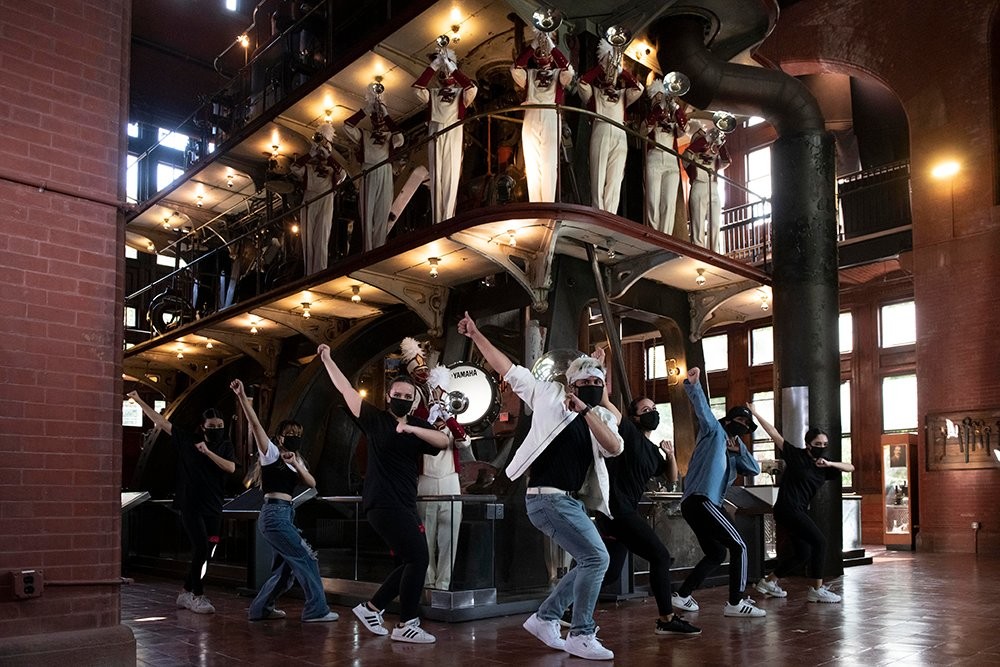 Dancers and musicians in an industrial space