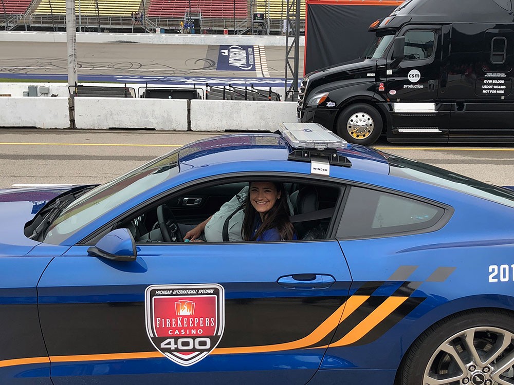 A woman driving a racecar