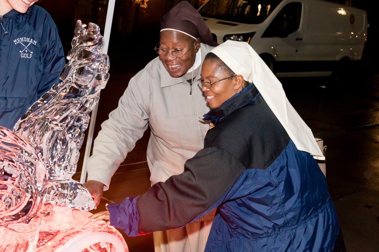 Women religious check out the ice sculpture.