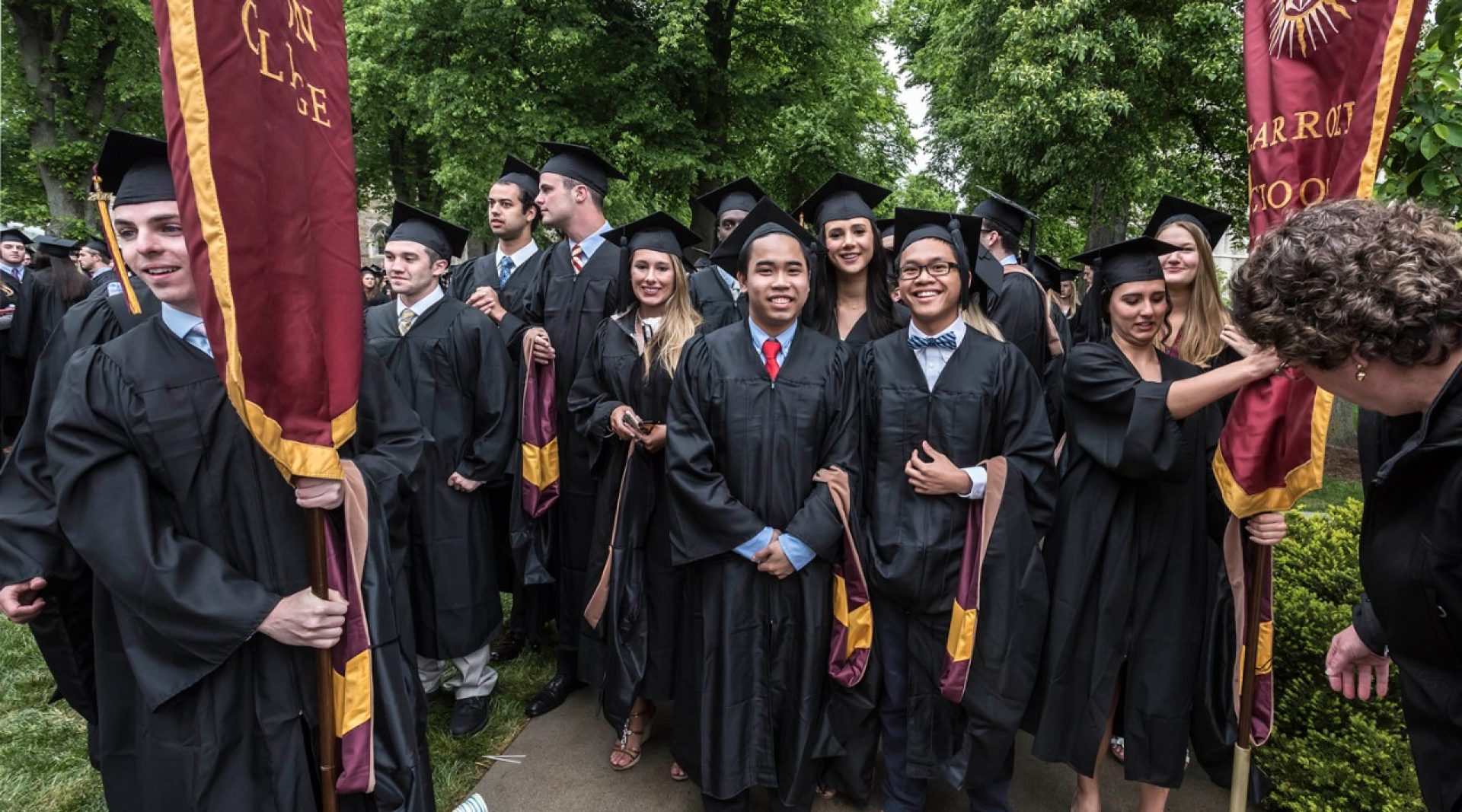 A BC graduate's mortarboard bears an image of Gasson Hall