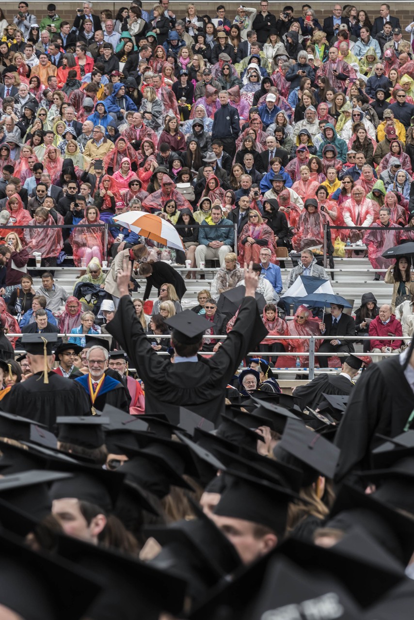 Scene from Alumni Stadium at BC Commencement; family members and friends in rain ponchos