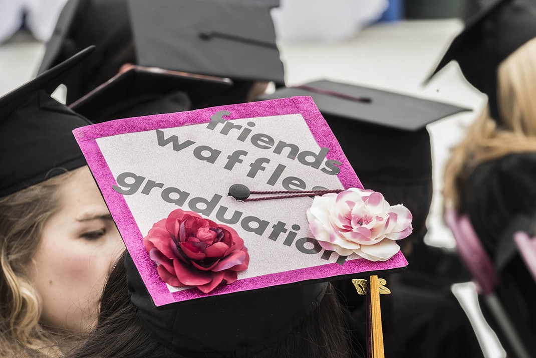 Mortarboard reads 'friends, waffles, graduation'