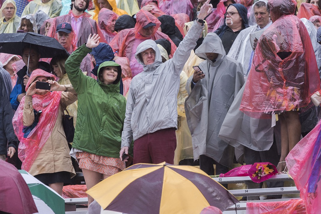 Scene from Alumni Stadium at BC Commencement; family members and friends in rain ponchos