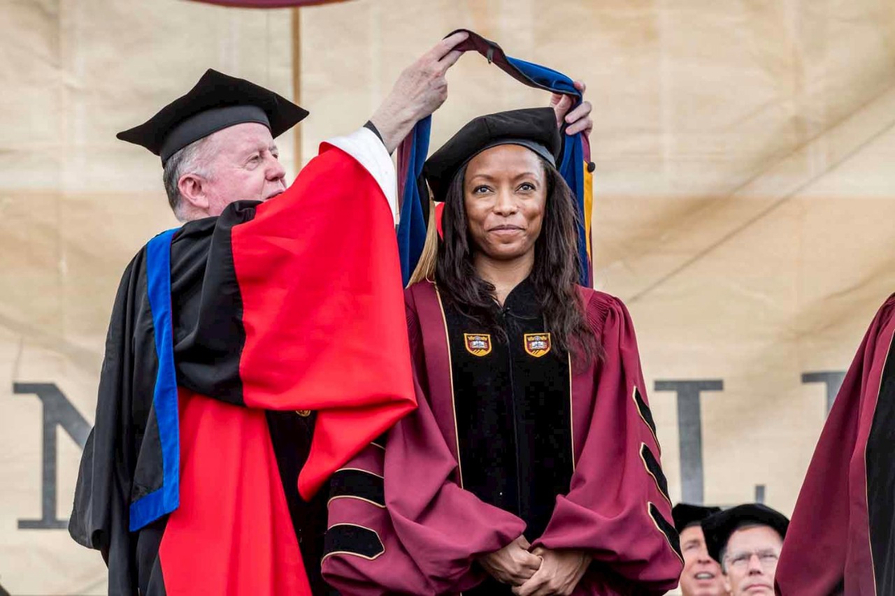 Graduate accepts diploma on behalf of class