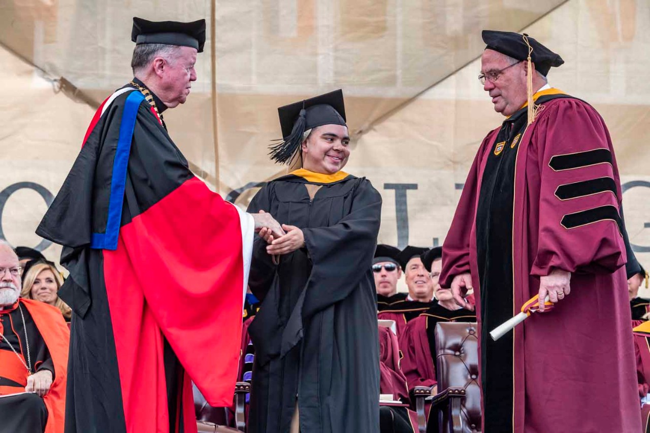 Graduate accepts diploma for the class
