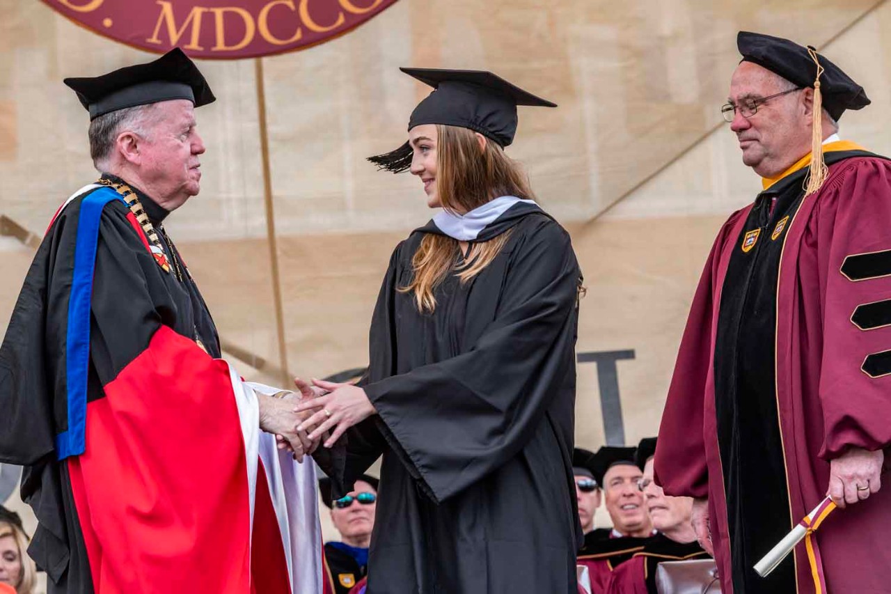 Graduate accepts diploma for the class
