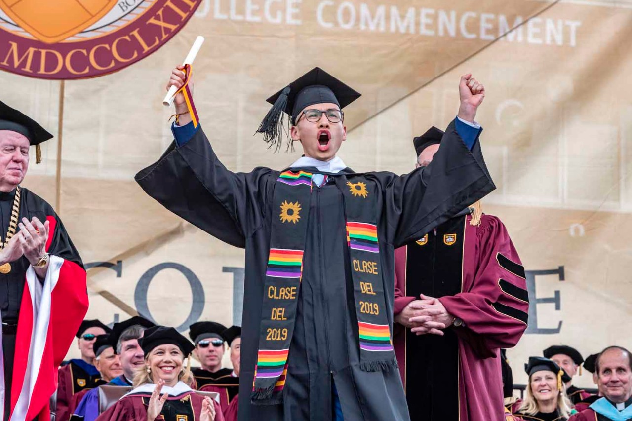 Graduate accepts diploma on behalf of class