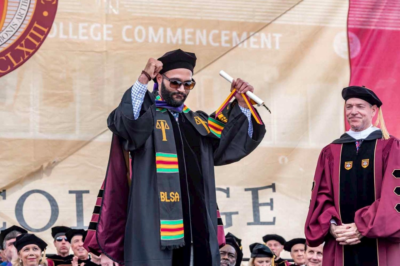 Graduate accepts diploma on behalf of class