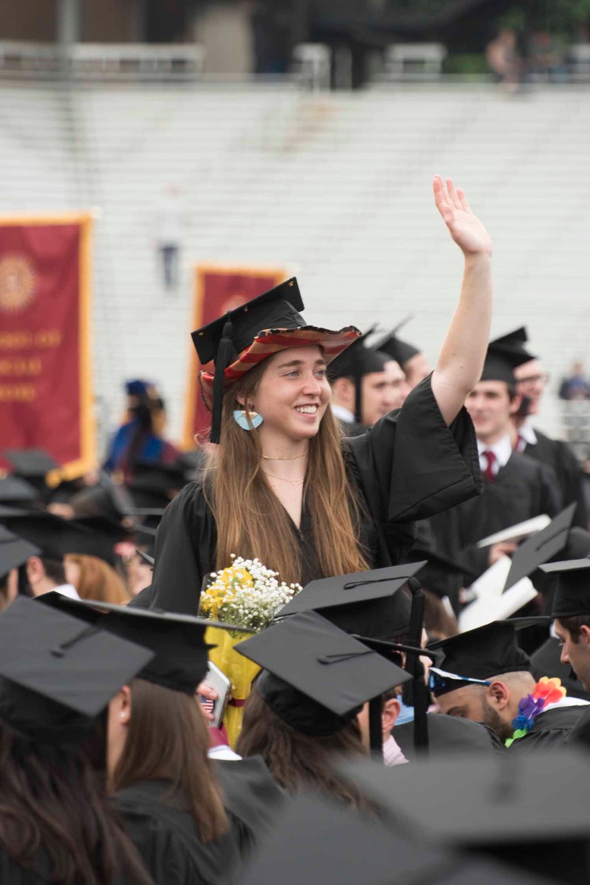 Graduate waving
