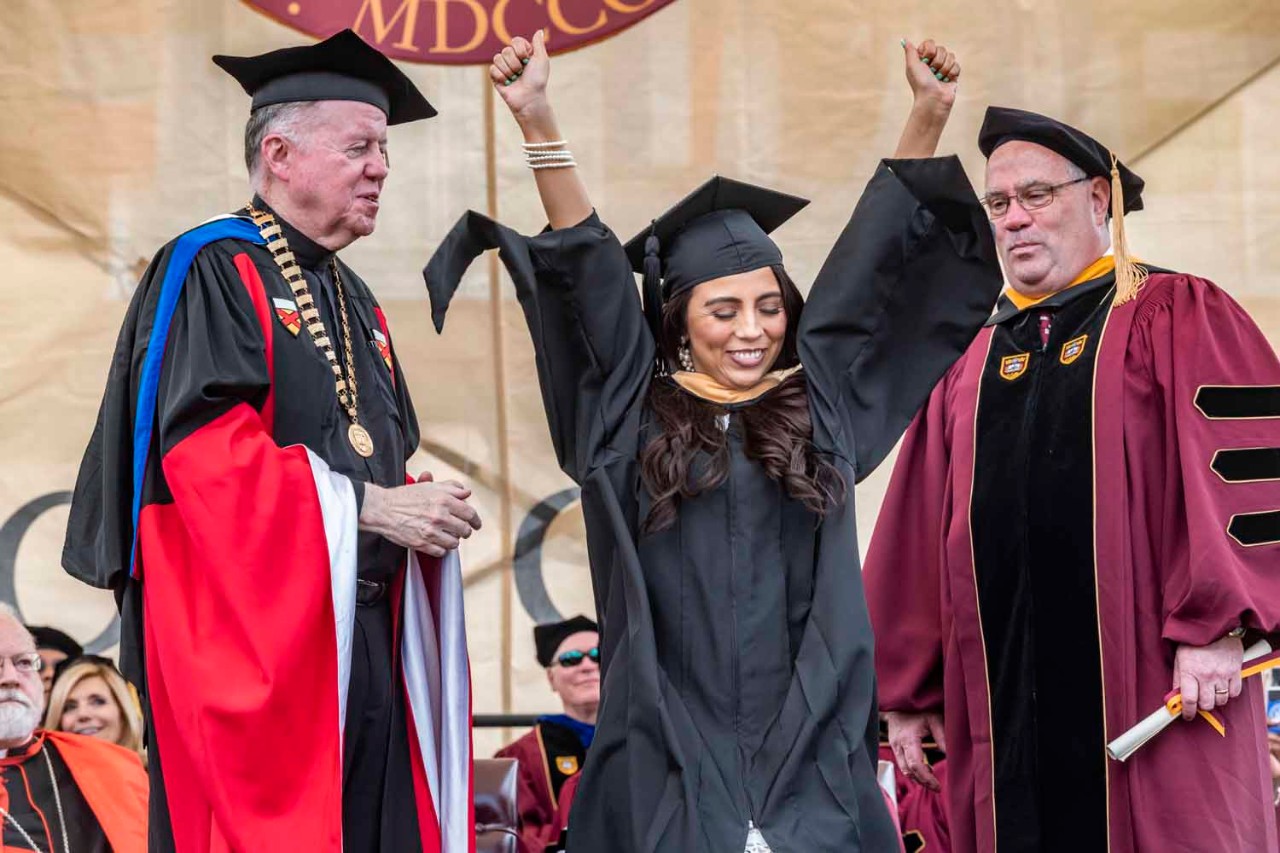 Graduate accepts diploma for the class