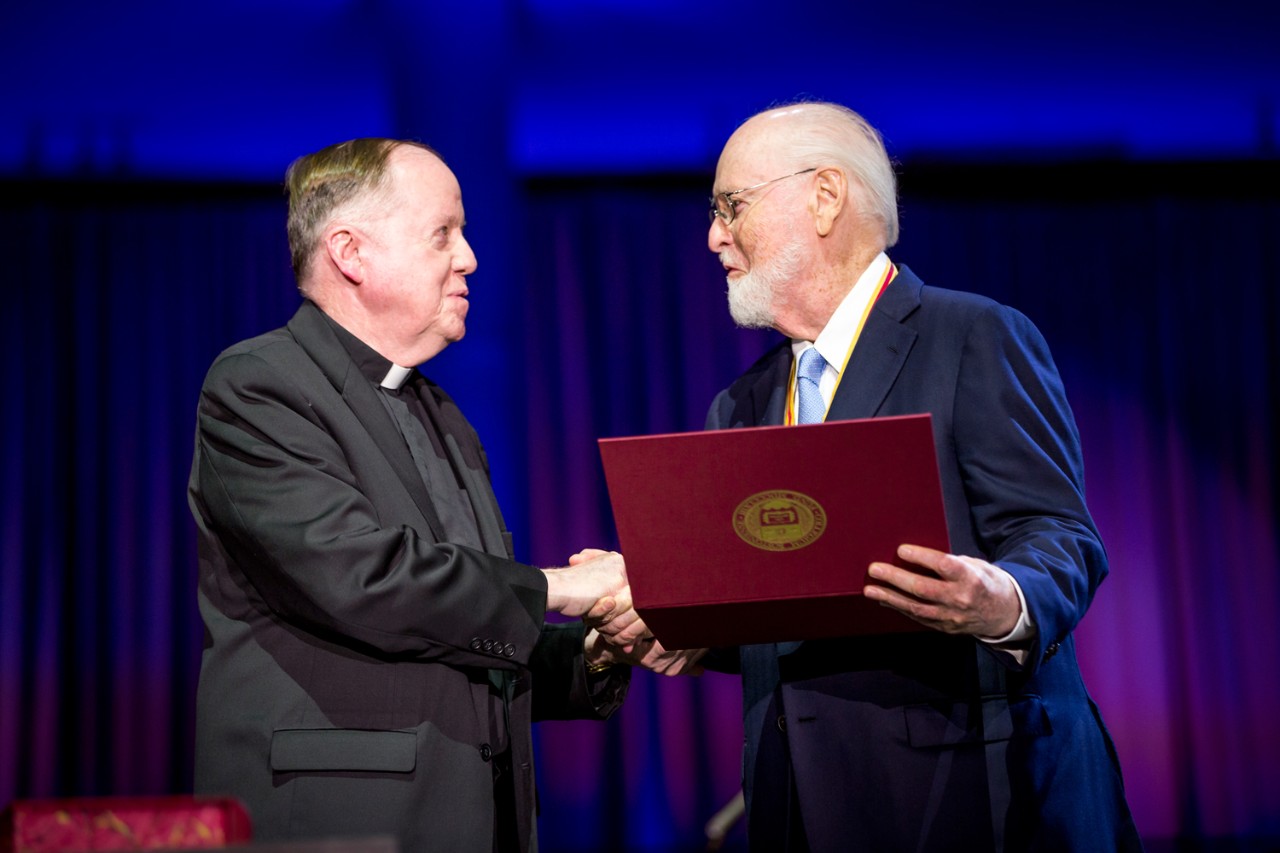 Boston College President William P. Leahy, S.J. congratulates President's Medal for Excellence recipient John Williams, one of America’s most successful composers for film and the concert stage, and a longtime friend to the University. (Caitlin Cunningham)