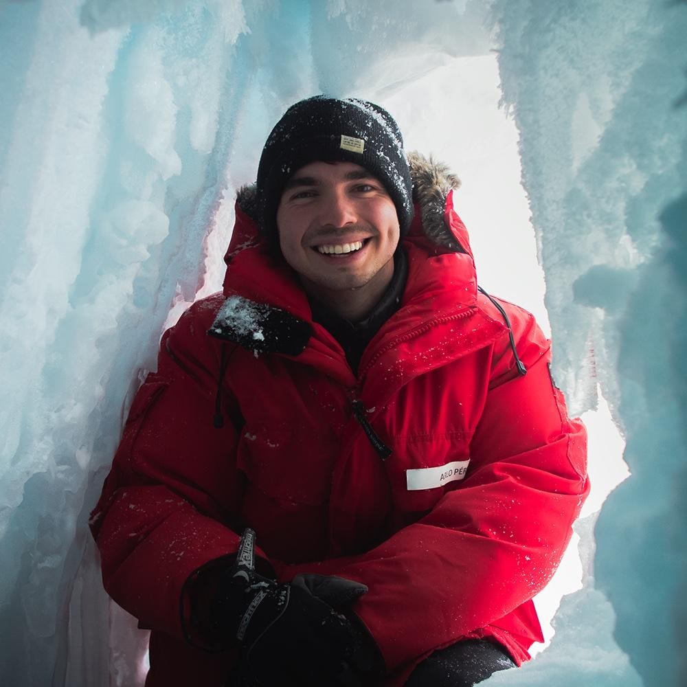 Arlo Perez standing in front of an ice wall