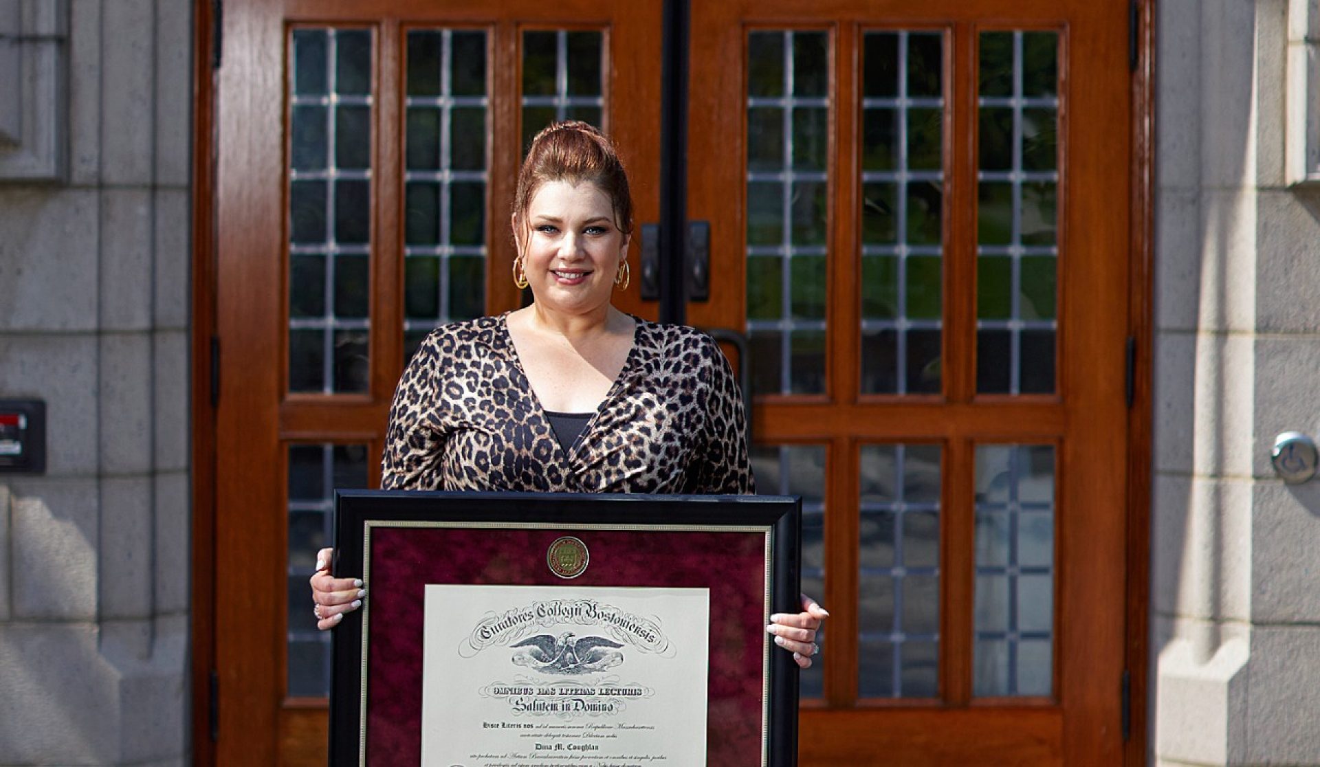 Dina Coughlan holding her diploma