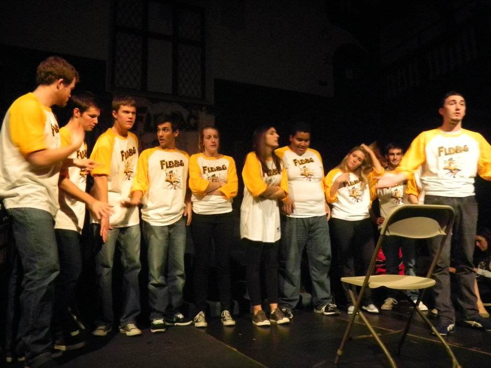 A group of improv actors standing on stage