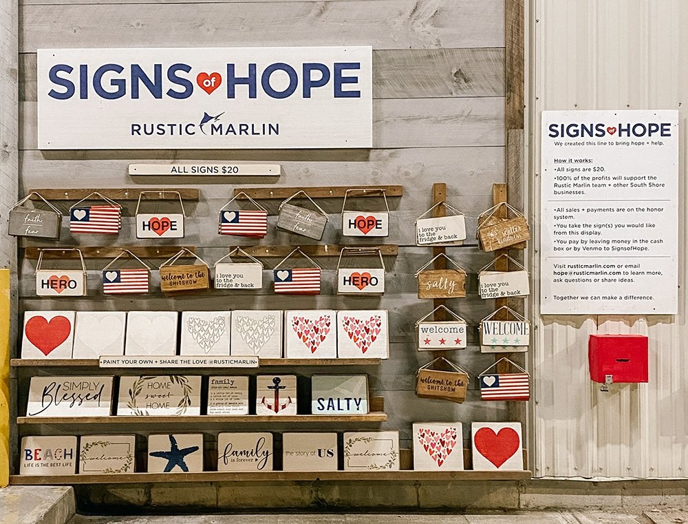 A kiosk containing many wooden signs