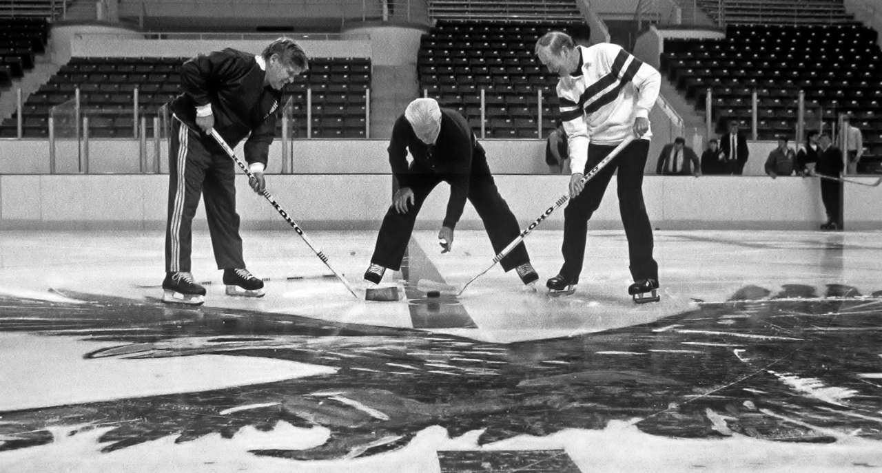Men's hockey coach Len Ceglarski (left) with Bill Flynn and Father Monan for the "First Skate."