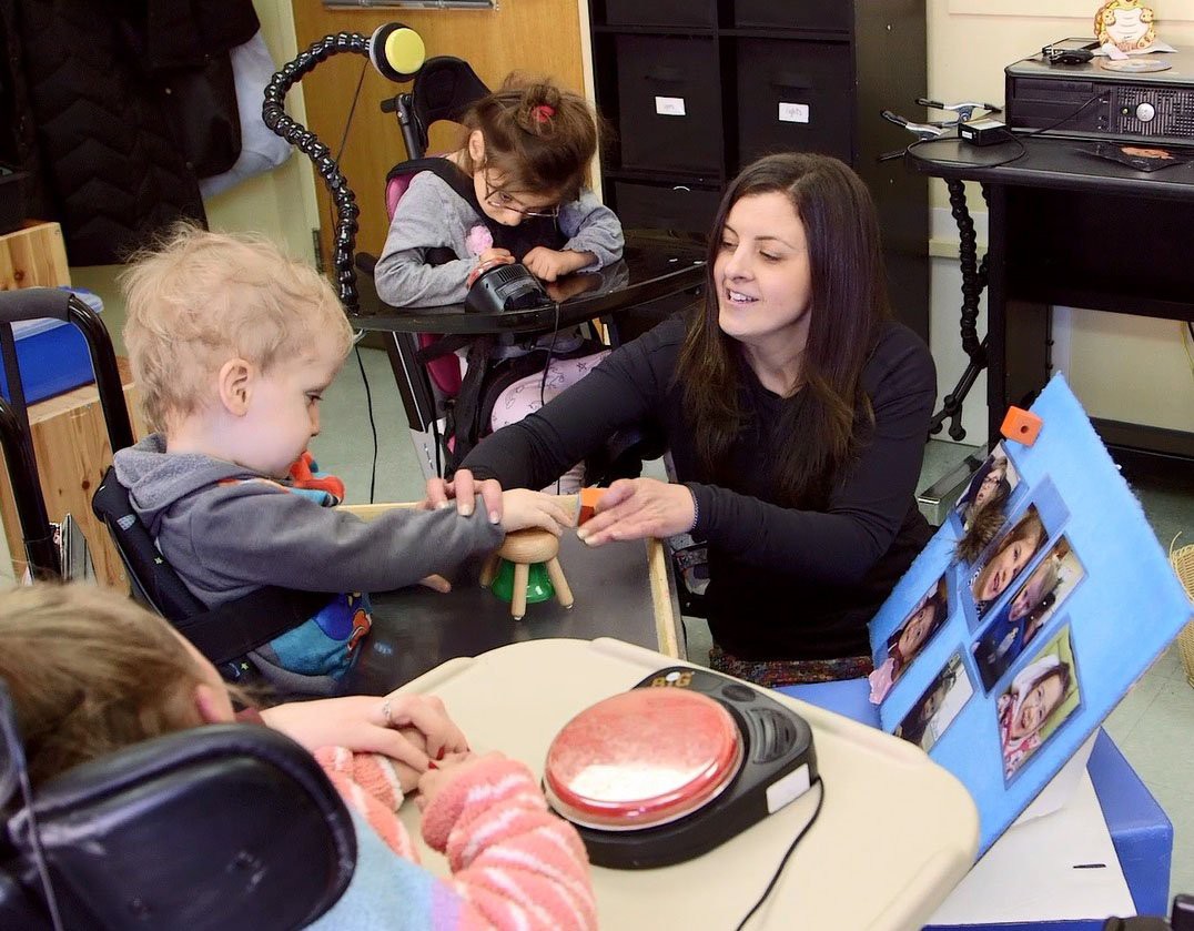 Pre-school teacher Sasha Greene with students at the Campus School