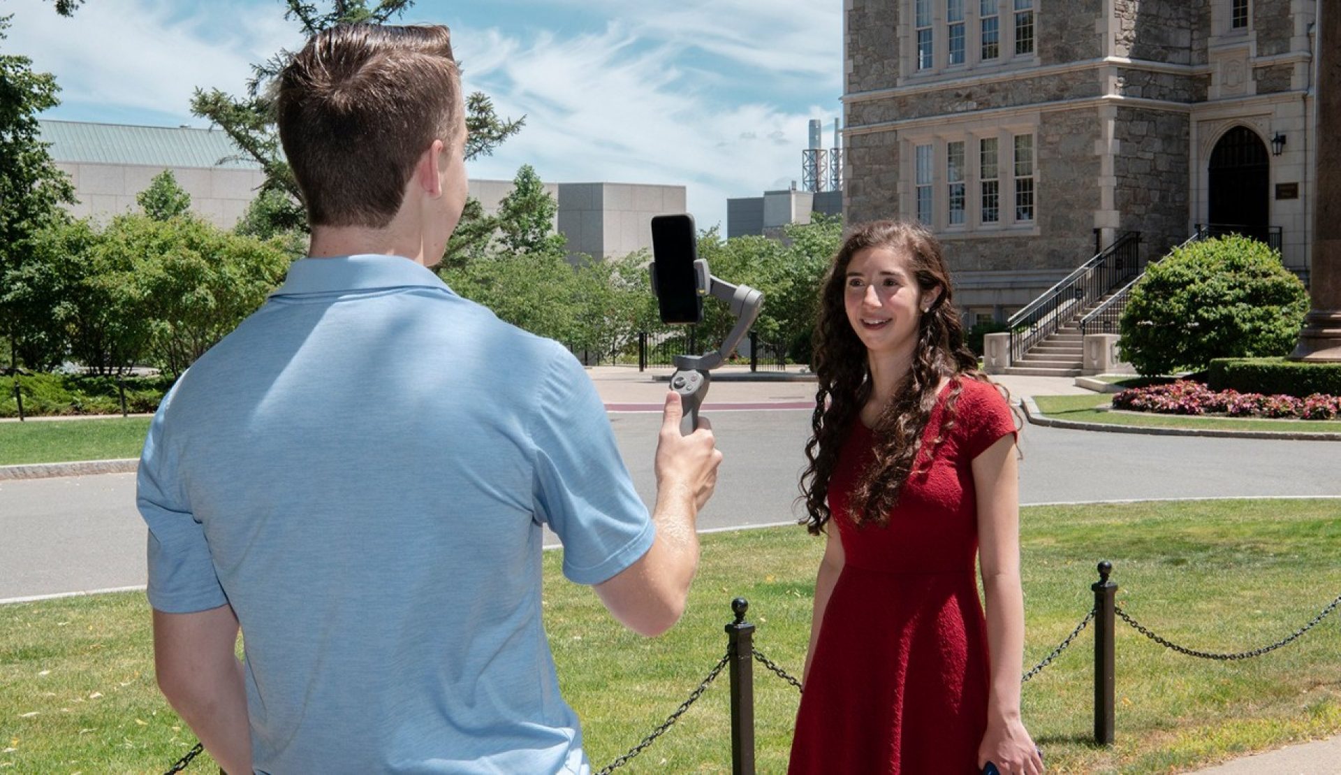 One student recording another student on a smartphone