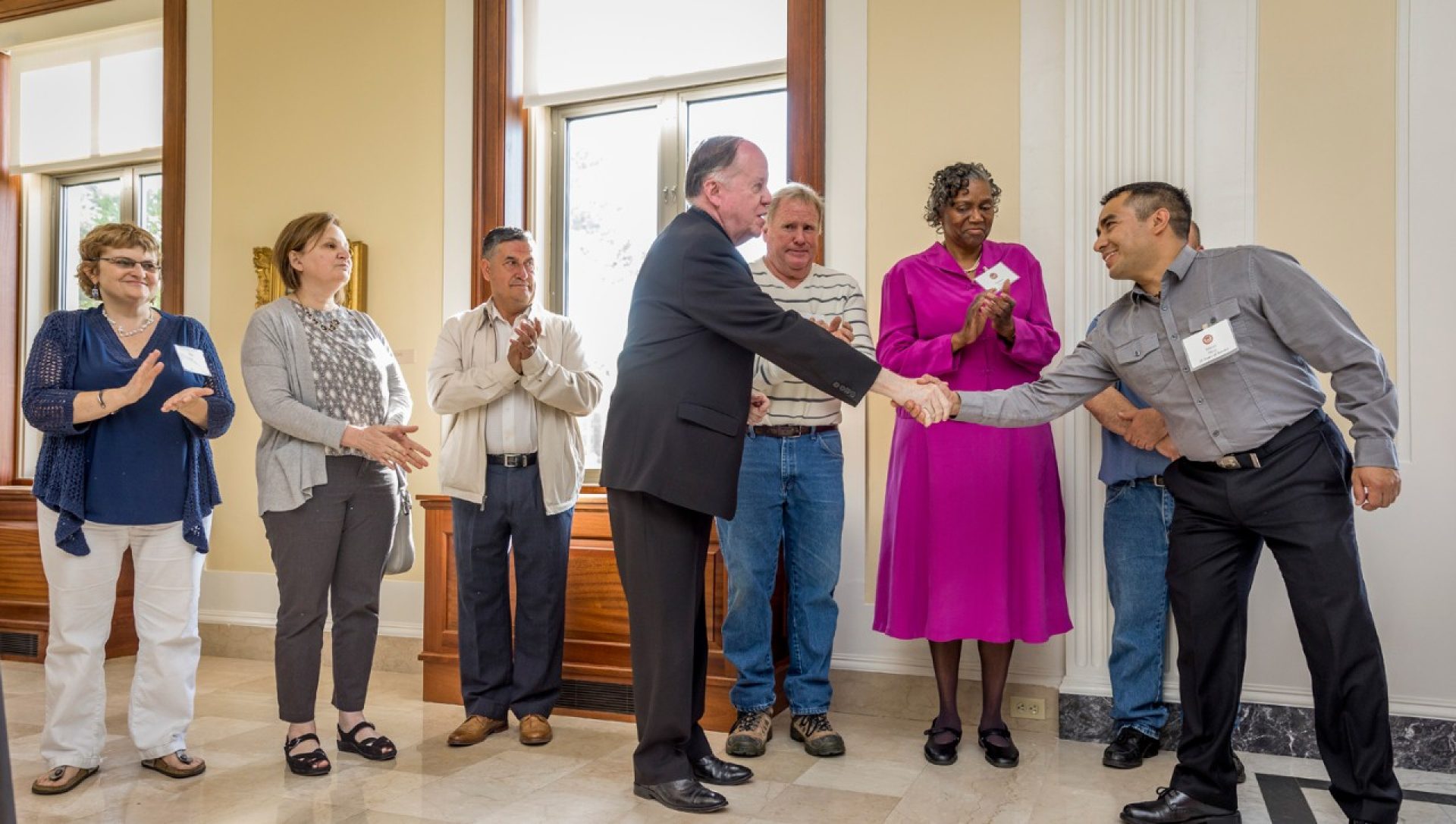 University President William P. Leahy, S.J., congratulates Marco Meza of BC Dining Services on 25 years of service.