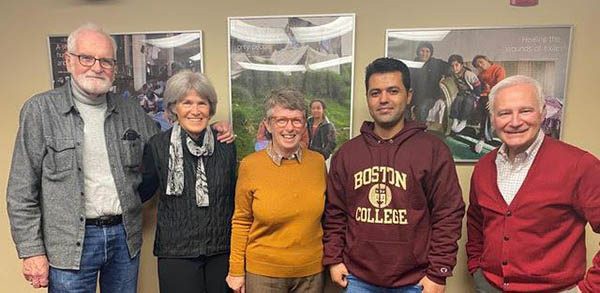 Farhad Sharifi standing with others in the St. Ignatius Parish office