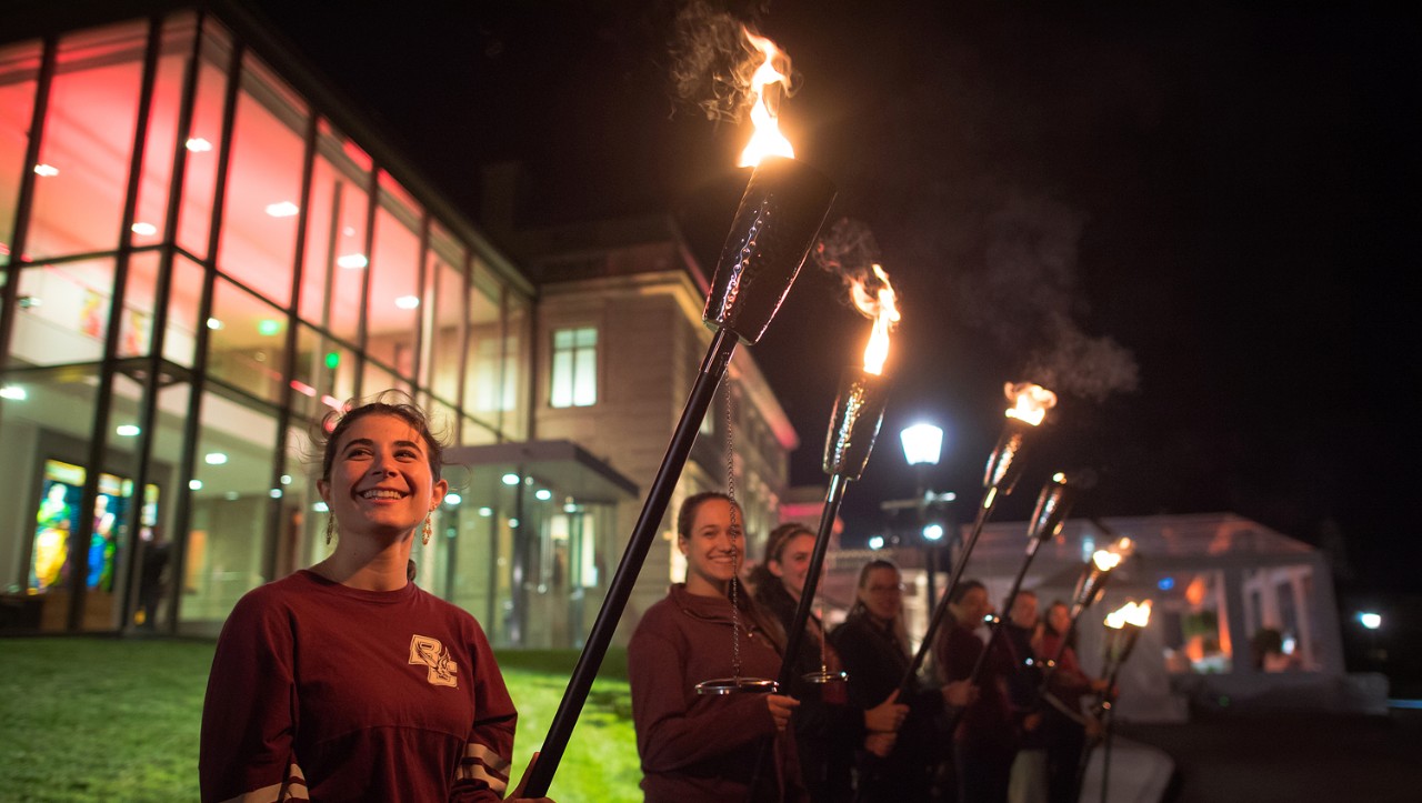 Students bearing torches to symbolize the 'Light the World' effort.