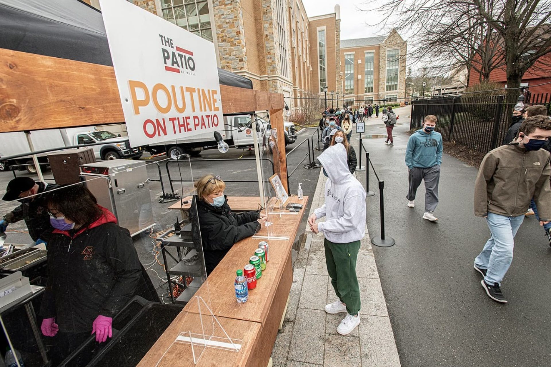 Students waiting in line at an outdoor food kiosk