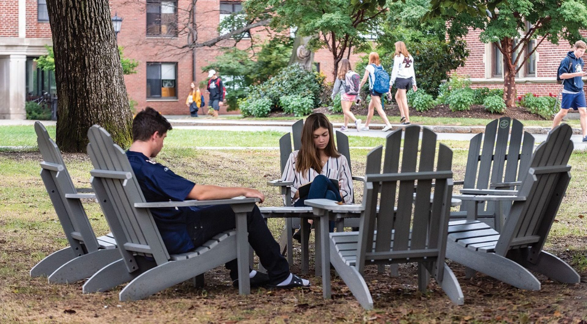 Students sitting in Adirondack chairs