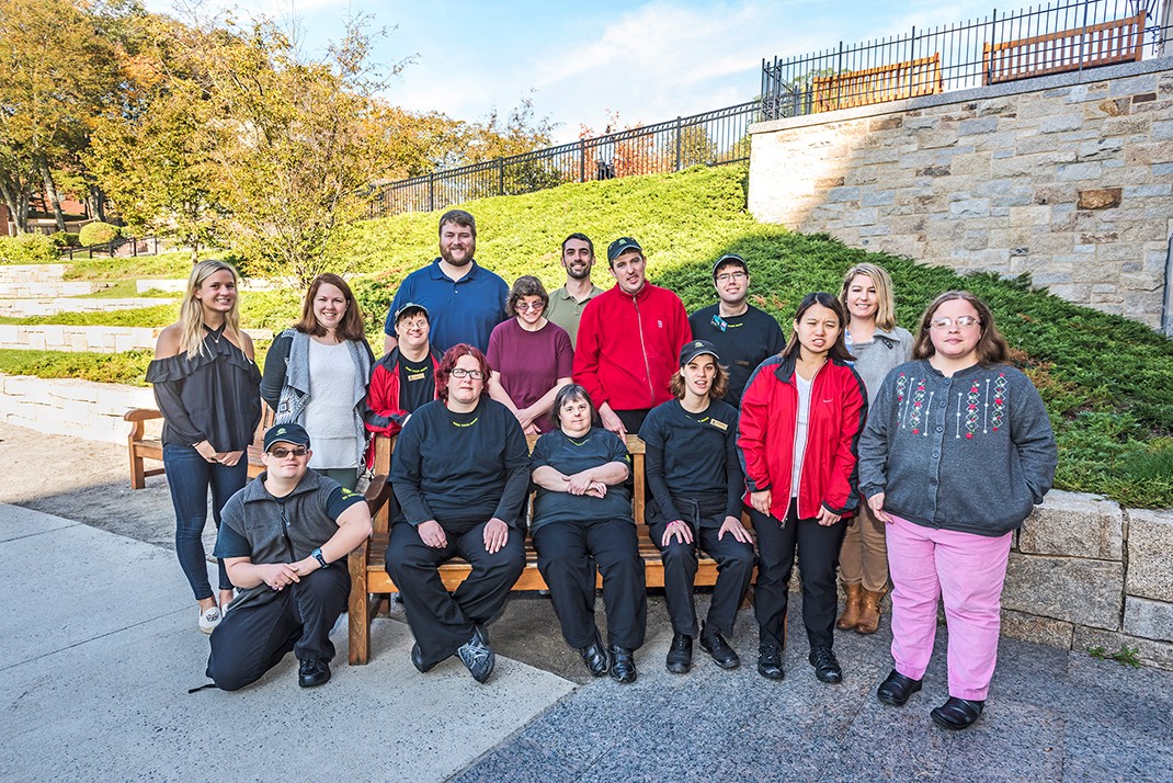 Supported Employment Program Coordinator Julianne Ferro (back row at right) with SEP employees and job coach- es. SEP participants “bring a variety of essential skill sets and colorful personalities that positively contribute to campus diversity,” she says. (Photo by Lee Pellegrini)