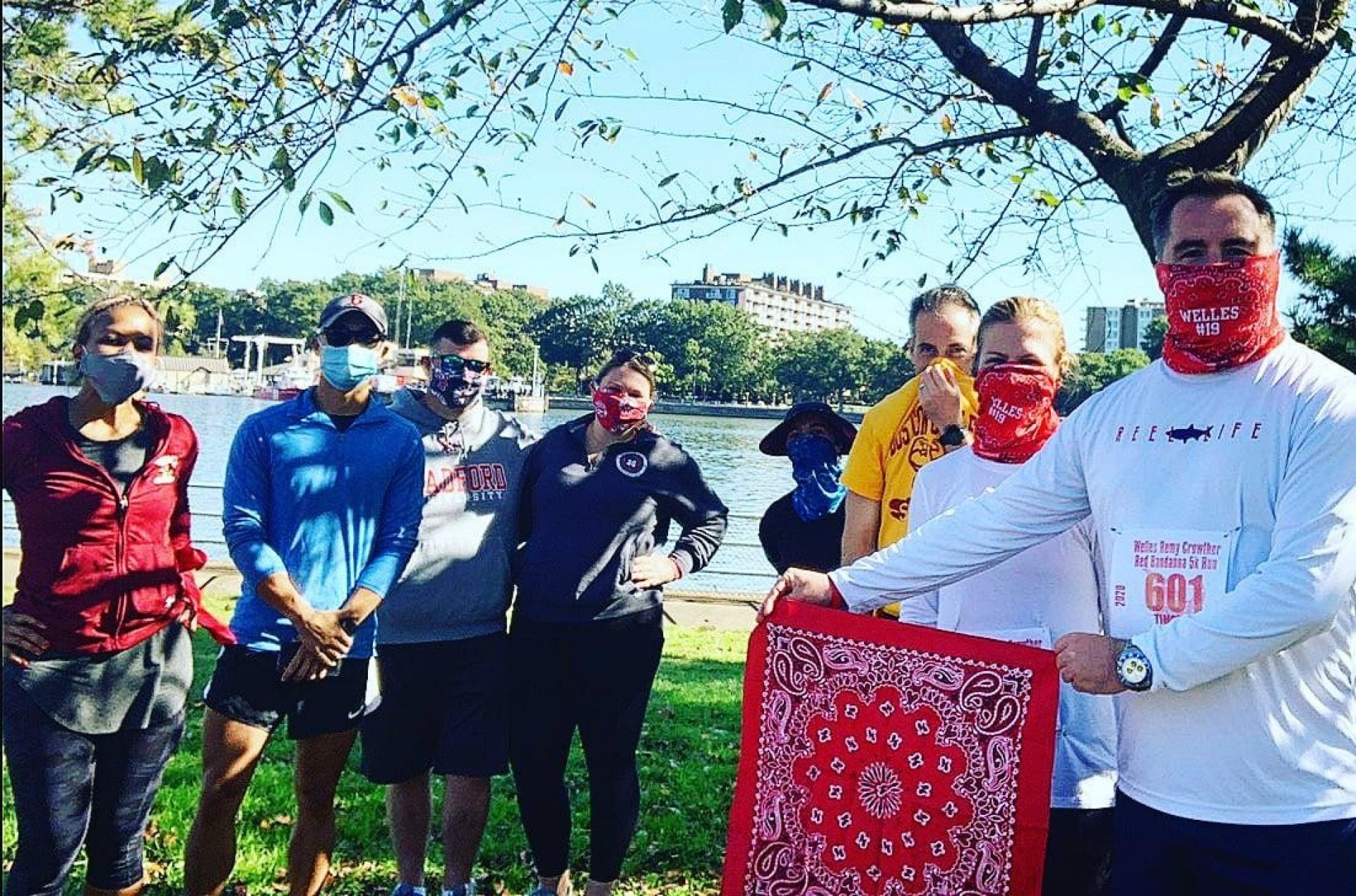 A group of runners holding a red bandanna