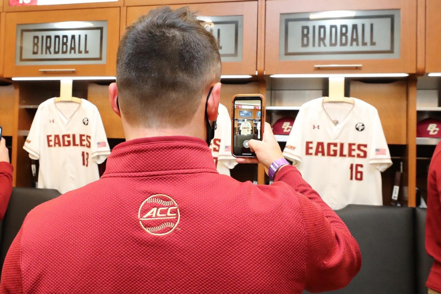 A student takes a photo of a locker room