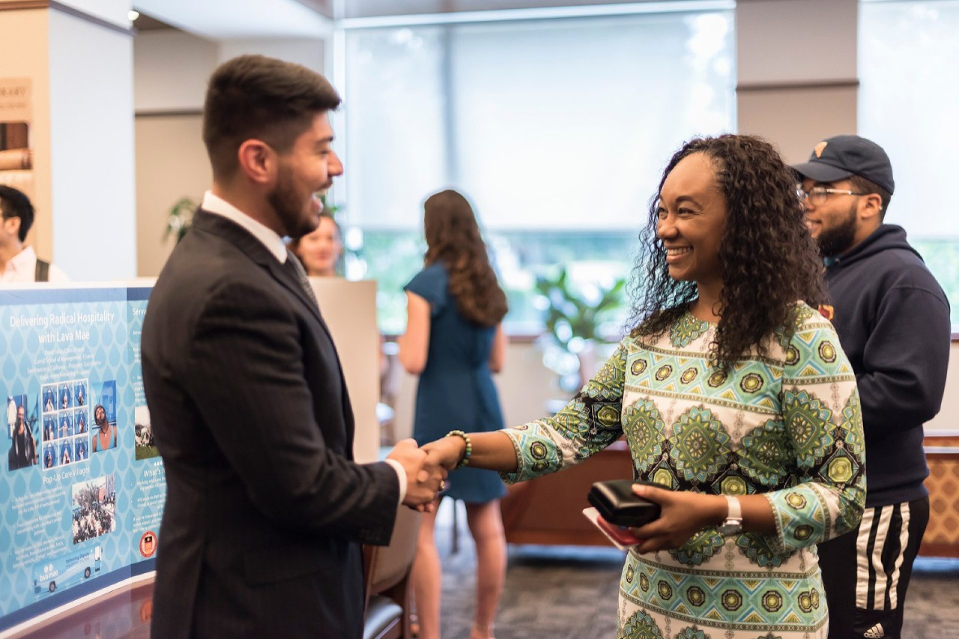 Thea Bowman AHANA and Intercultural Center Director Ines Maturana Sendoya congratulated David Jasso ’20 at a presentation/reception event for participants in the Eagle Intern Fellowship Program. (Photo by Yiting Chen)