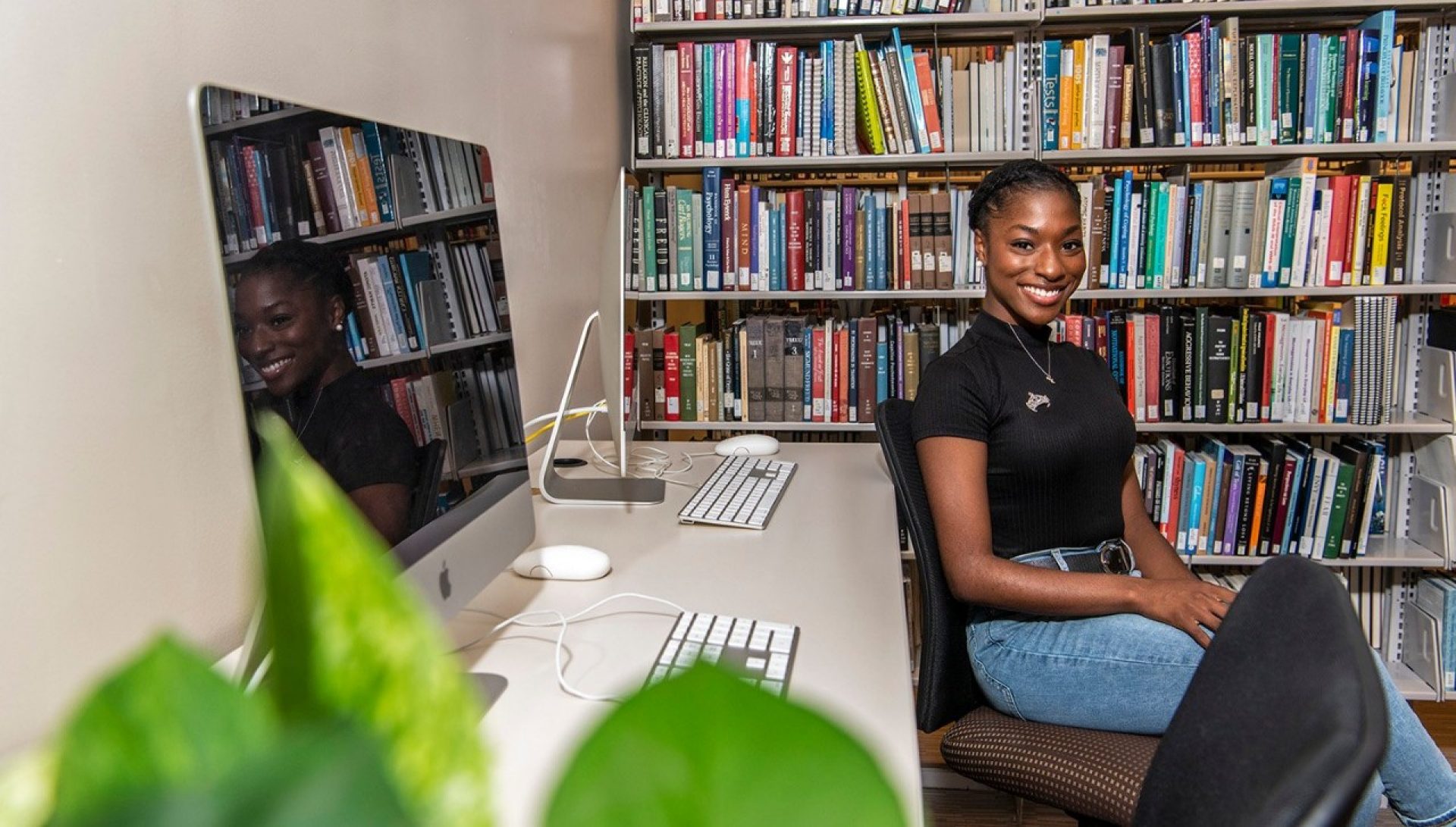 Elizabeth Pierre sitting in a library