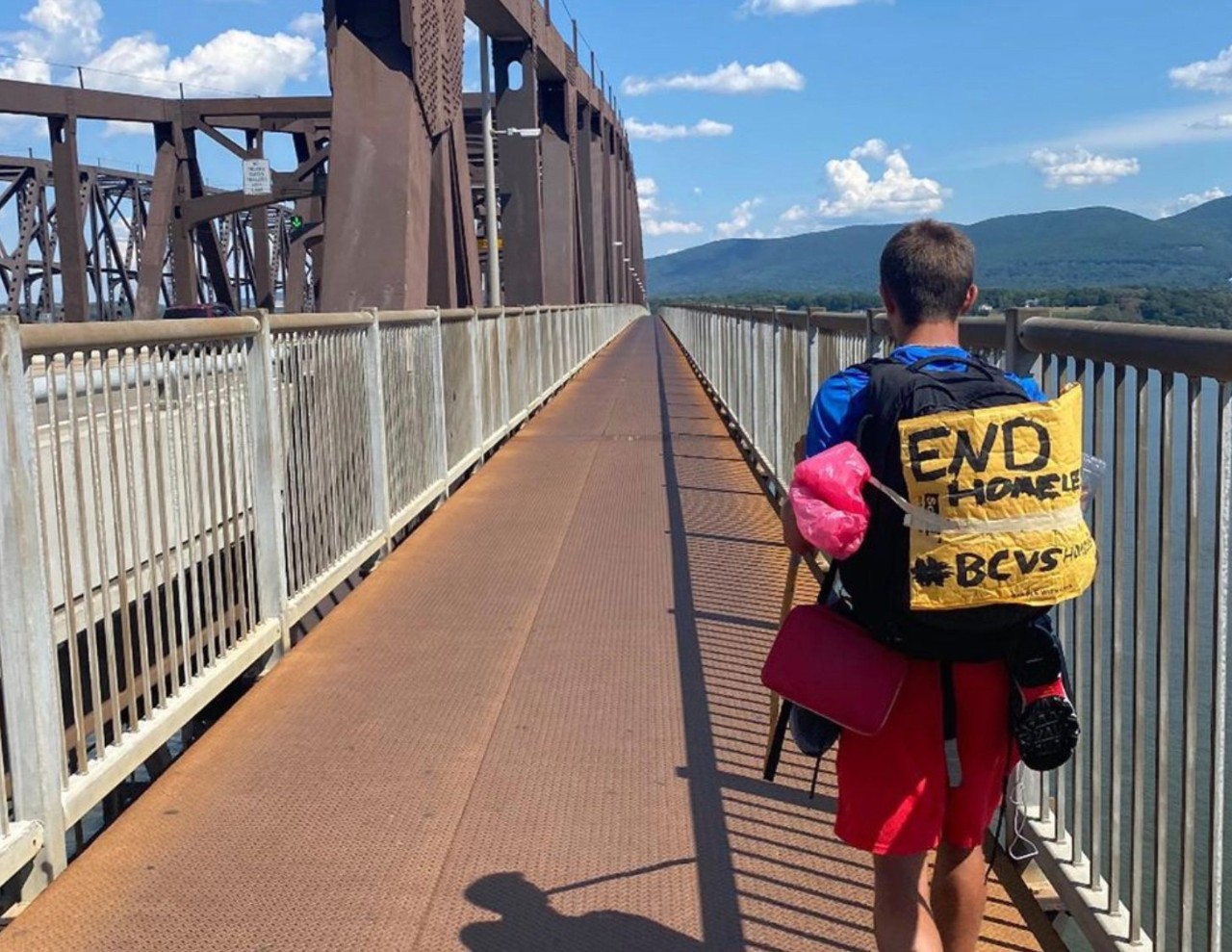 Gordon Wayne walking across a bridge