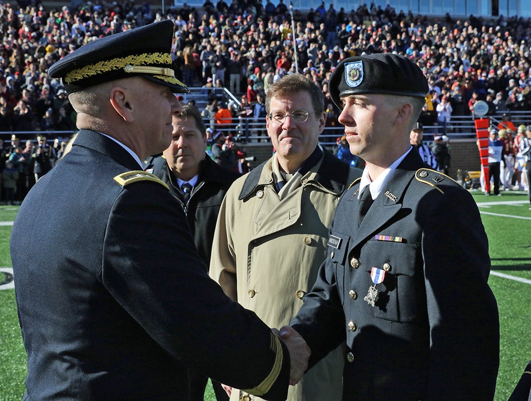 Cadet Mark Kindschuh shakes hands with Maj. Gen. Christopher Hughes